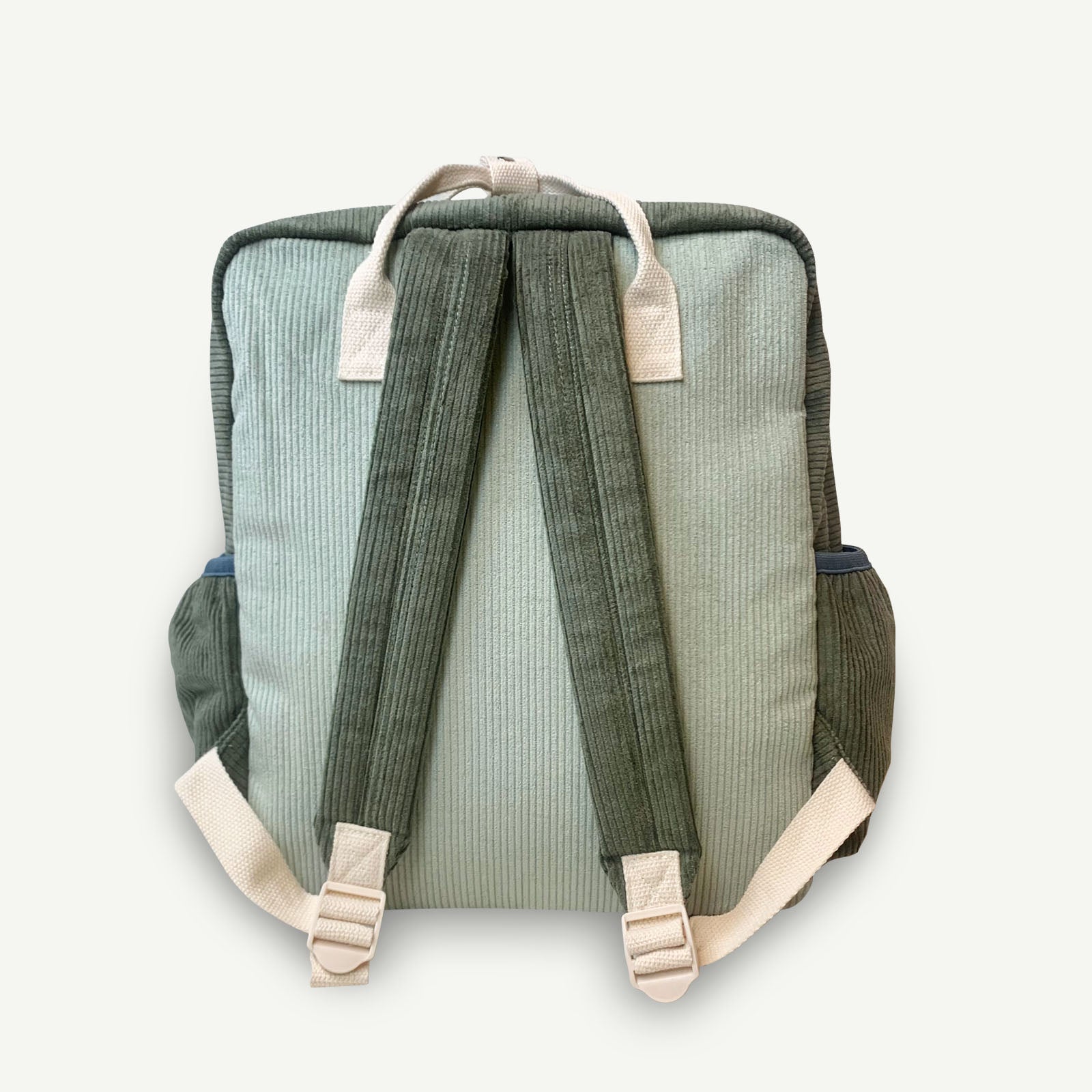 Back side of the green and blue cord backpack