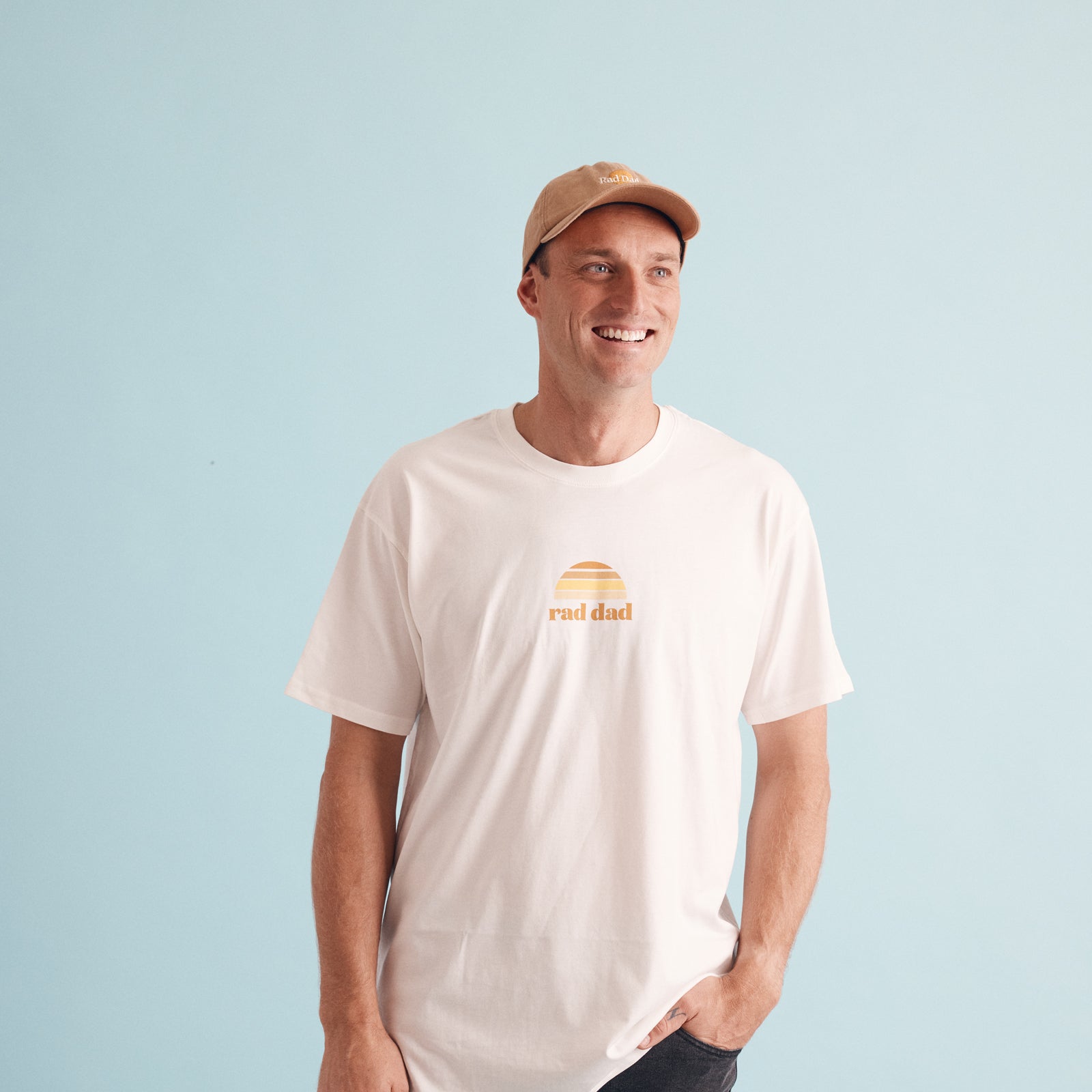 Man wearing White "Rad Dad" tee and Tan baseball cap