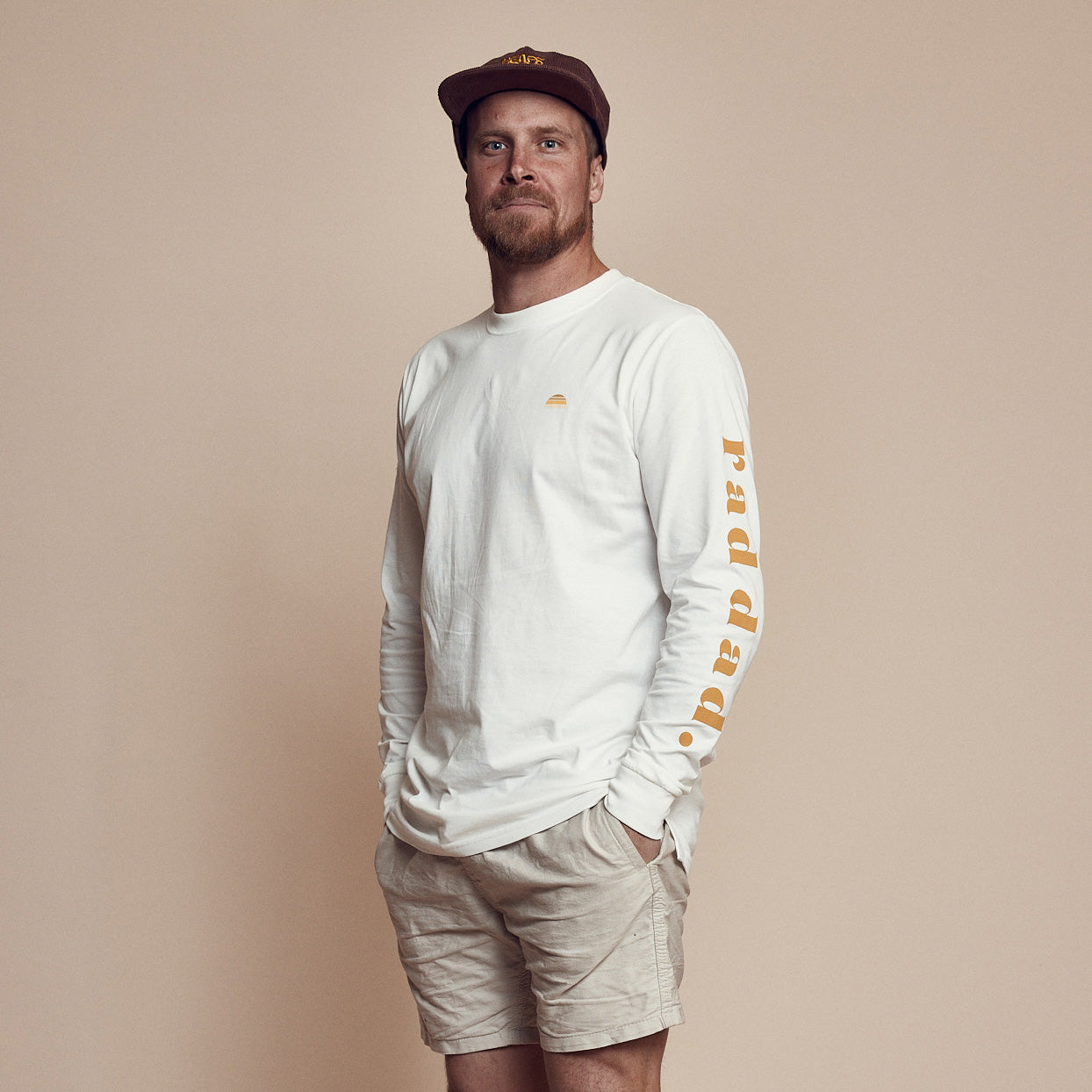 A long sleeve white t-shirt with the text 'rad dad' printed on the back and arm