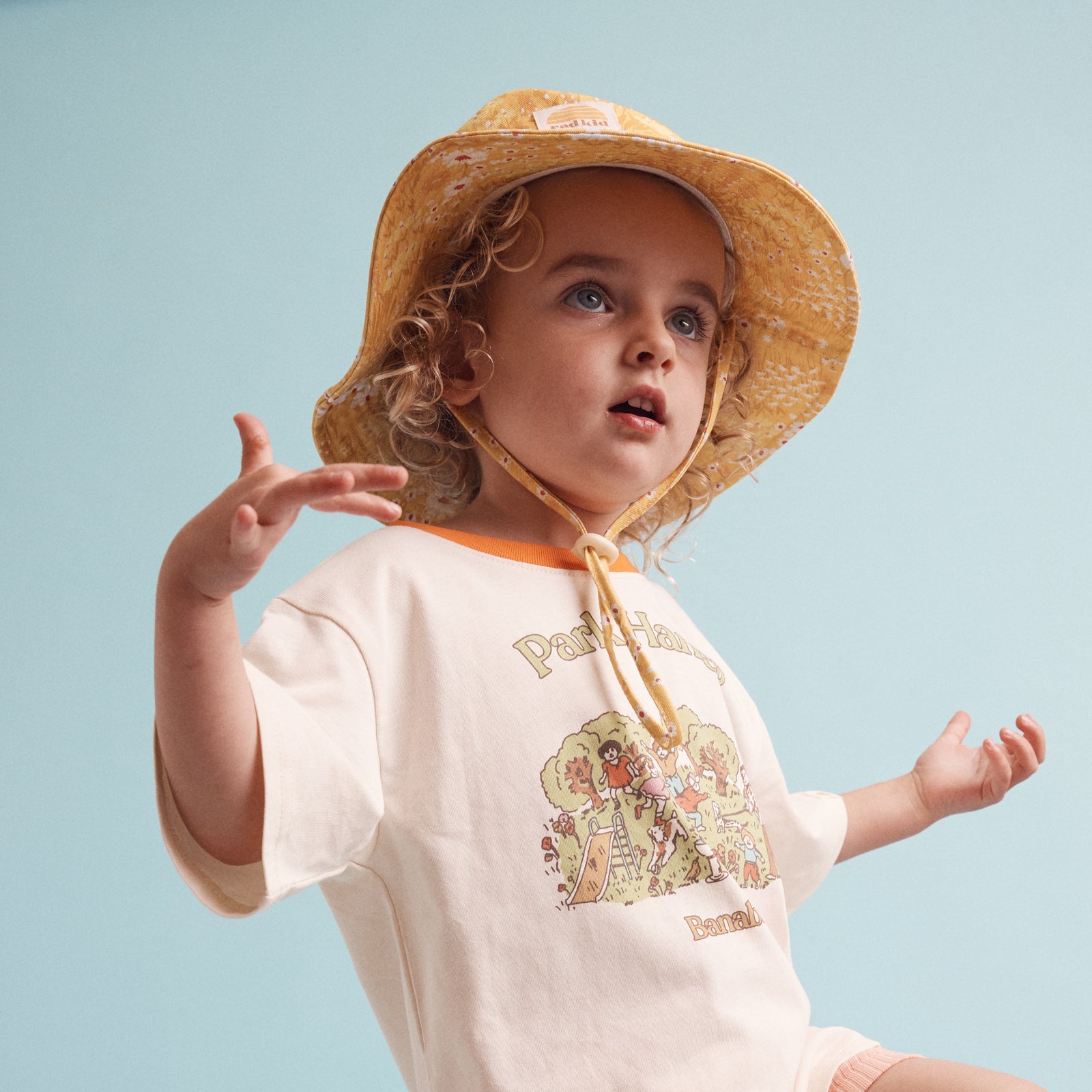young child wearing he Rad Kid Buttercup print bucket hat