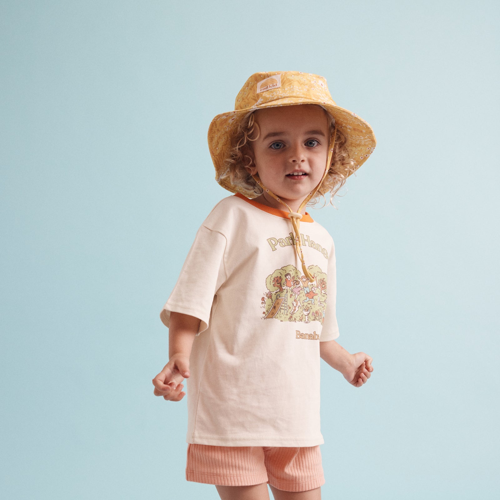 young child wearing he Rad Kid Buttercup print bucket hat