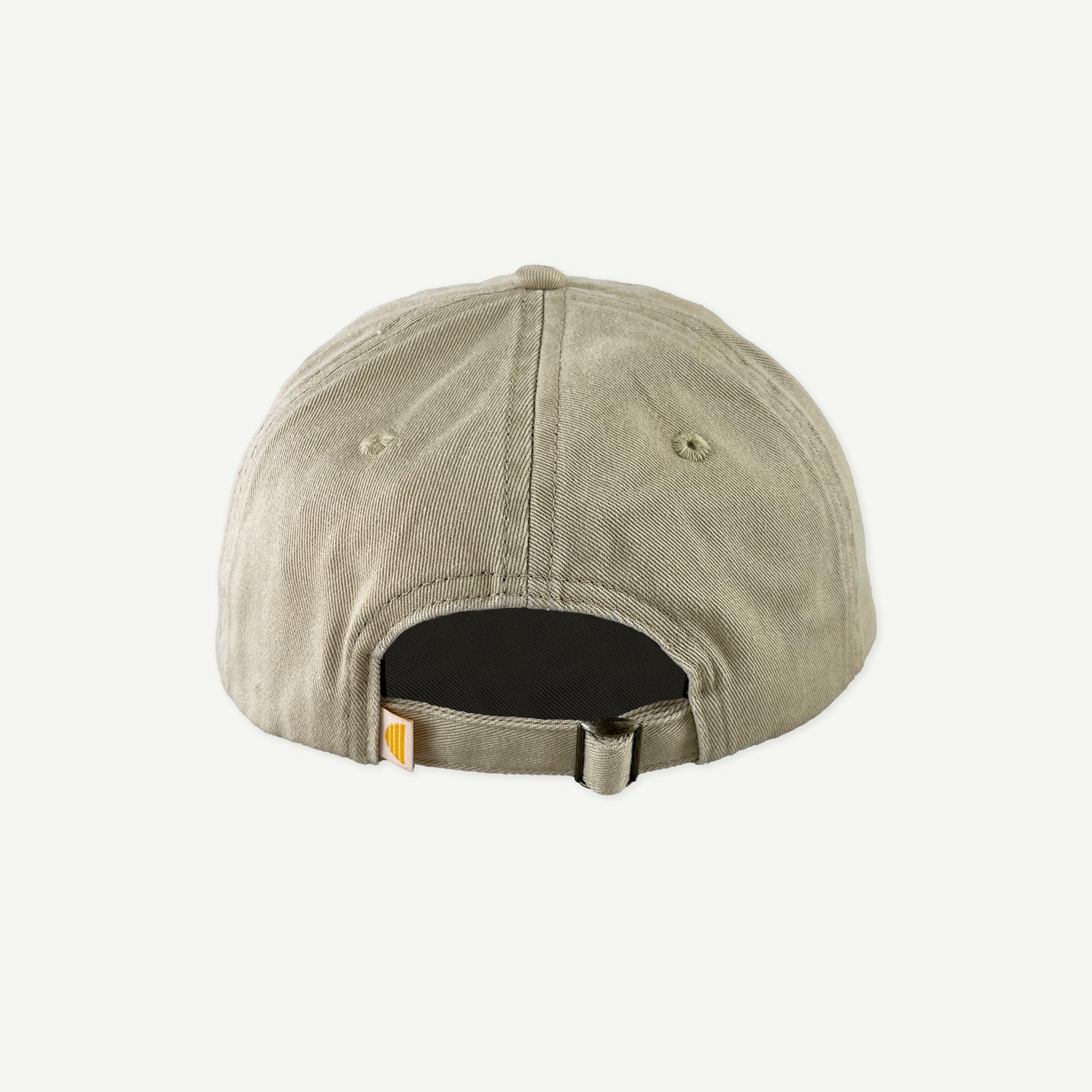 Back view of Banabae washed sand cap in organic cotton twill, showing the center back bronze metal slid adjusted at back.