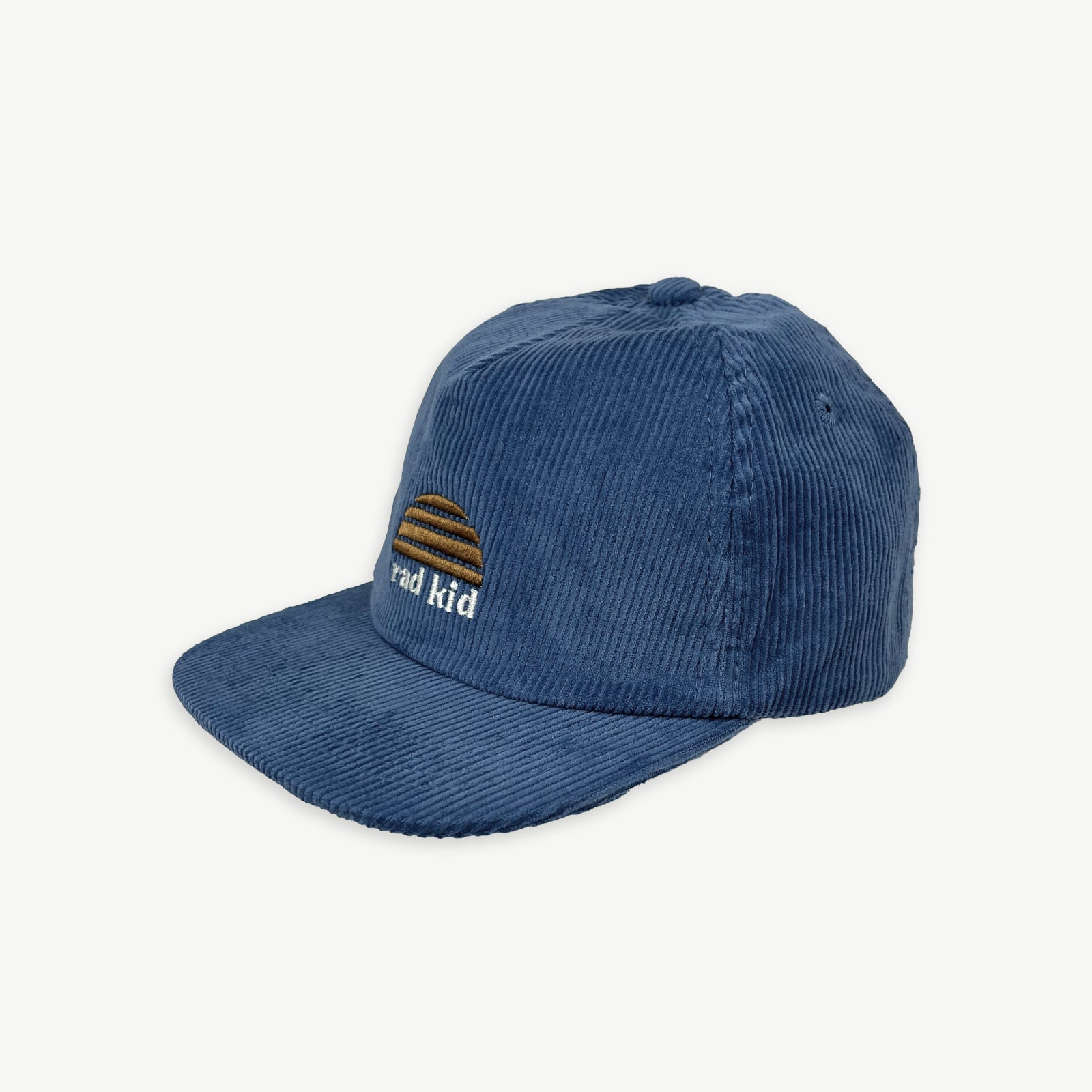 off centered image of Blue ,corduroy peak front cap with rad kid embroidered at center front and a sun logo embroidered above in yellow.