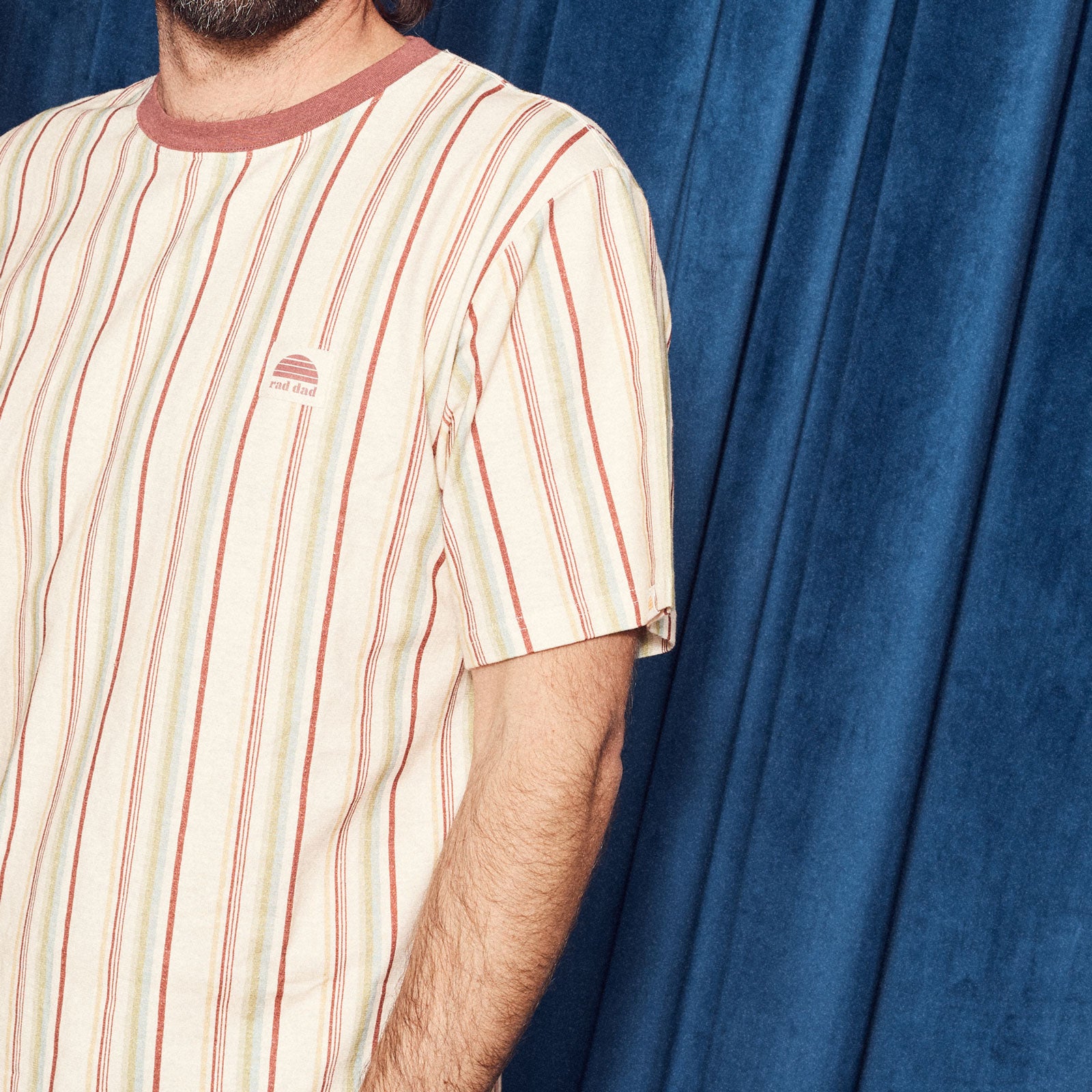 Person wearing a striped shirt 'rad dad' logo