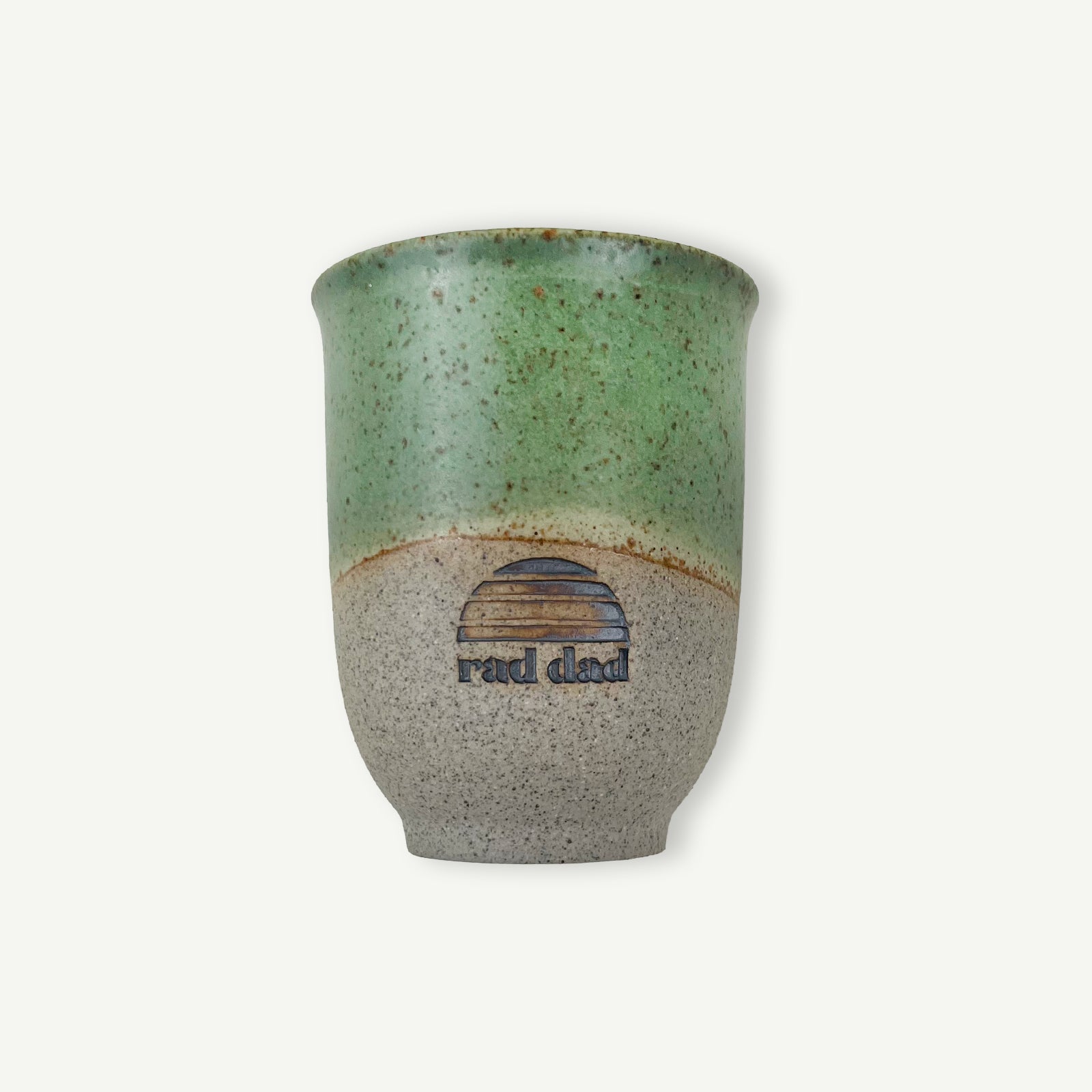Green and gray ceramic cup with 'rad dad' text on a white background
