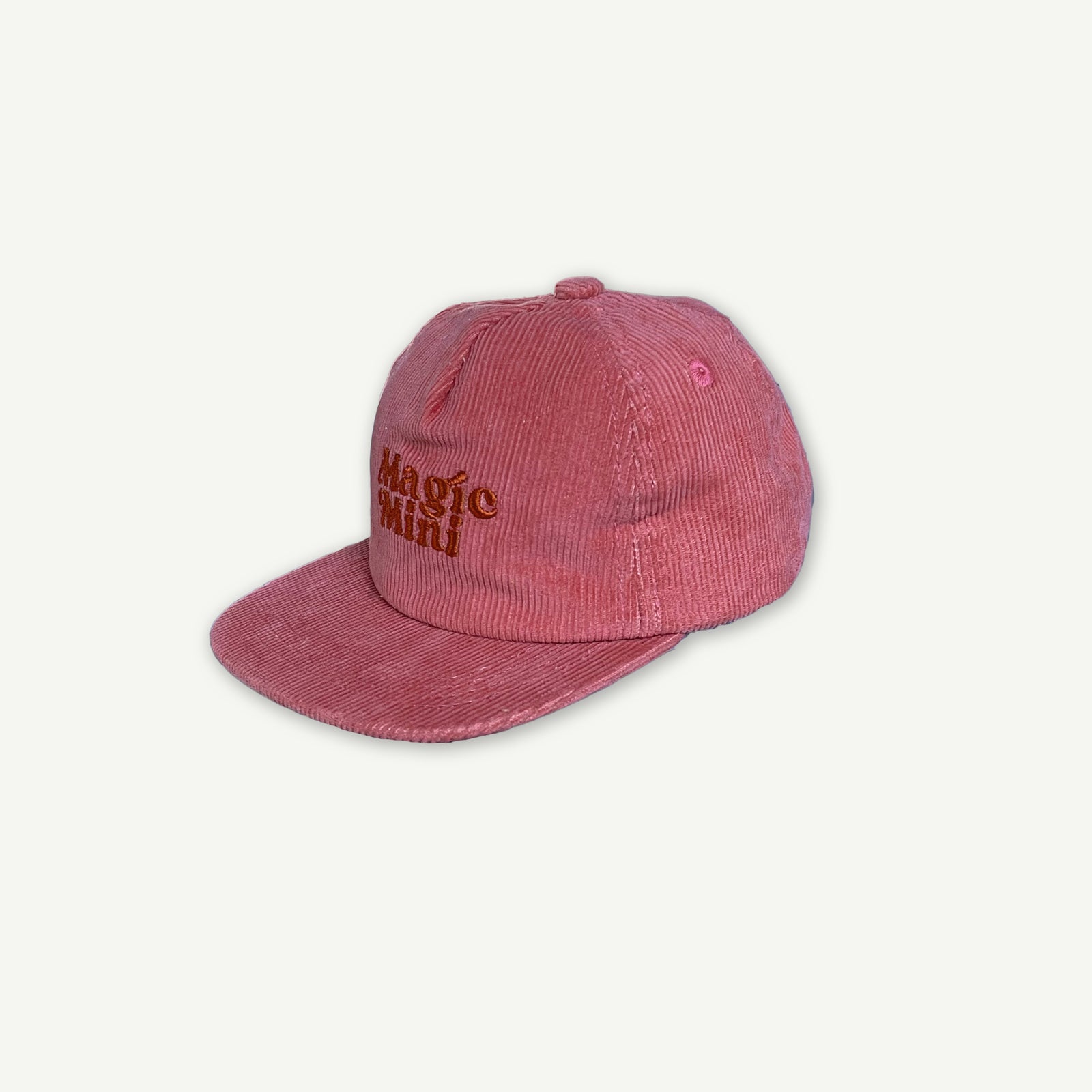 Side view of Magic Mini Cord Cap. Cap is Pink with Magic Mini embroidered on the center front