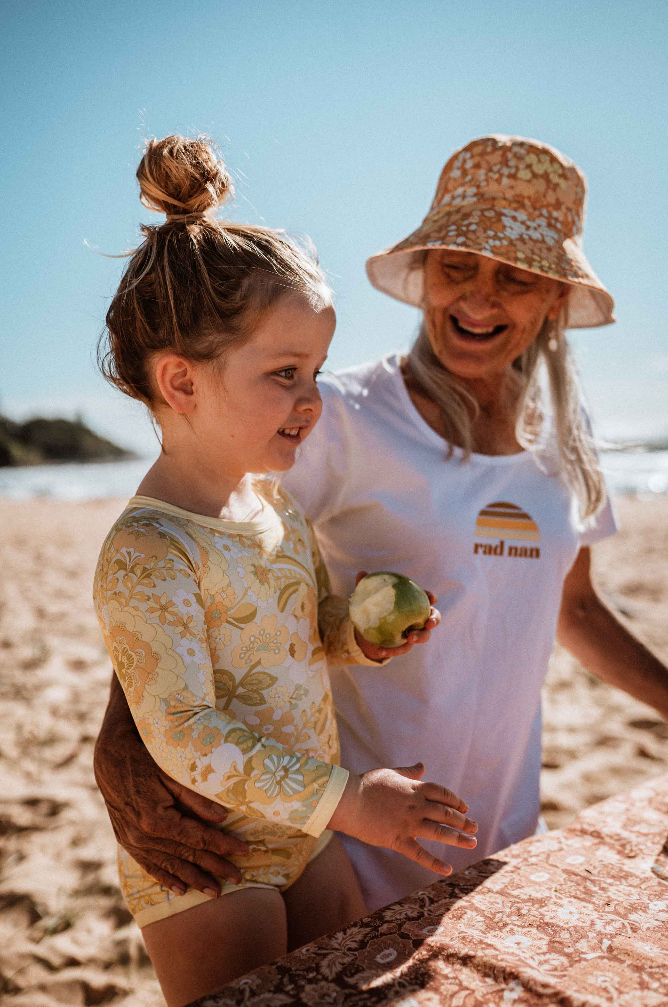 rad nan with granddaughter on the beach