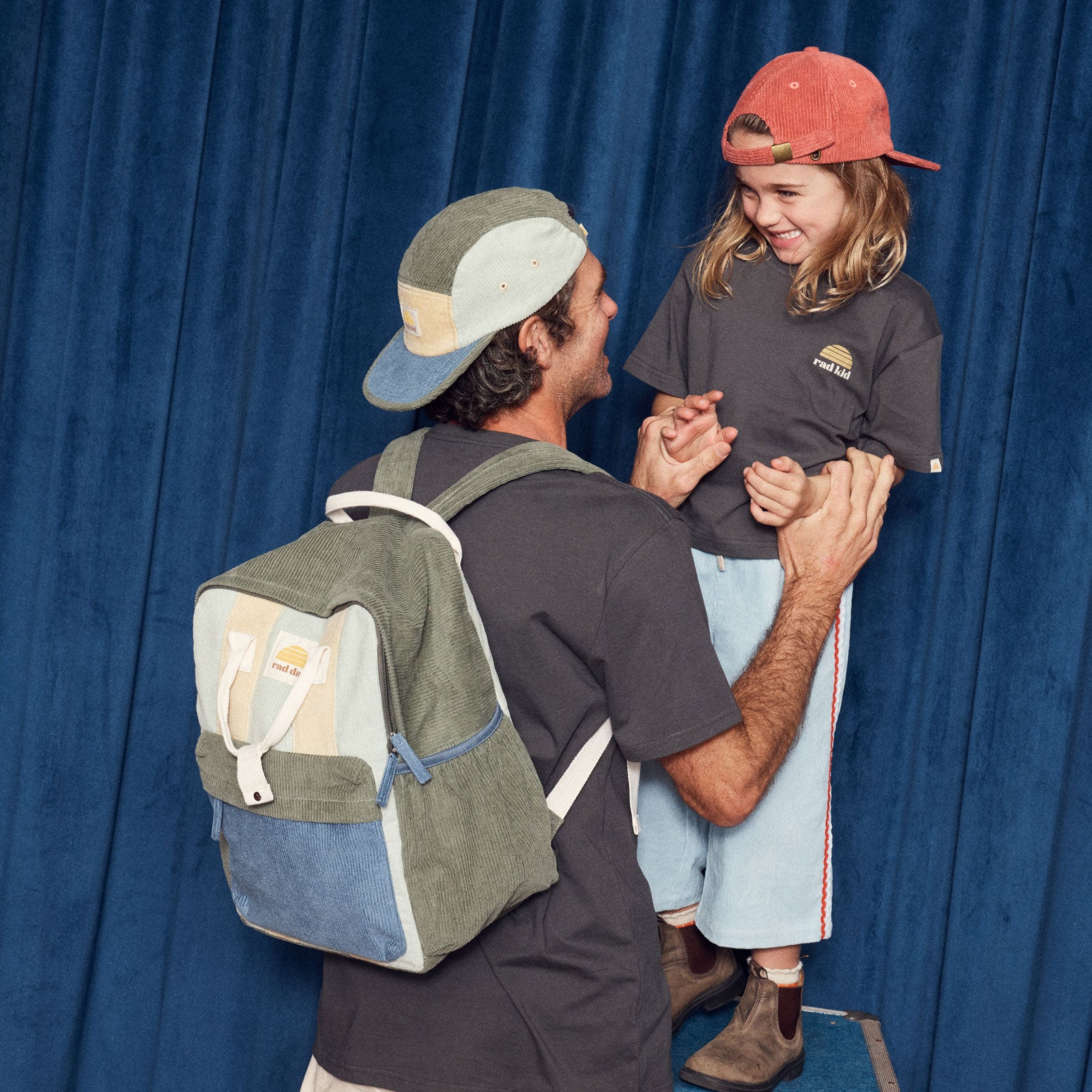 Man with a 'rad dad' backpack wearing 'rad dad' cap 