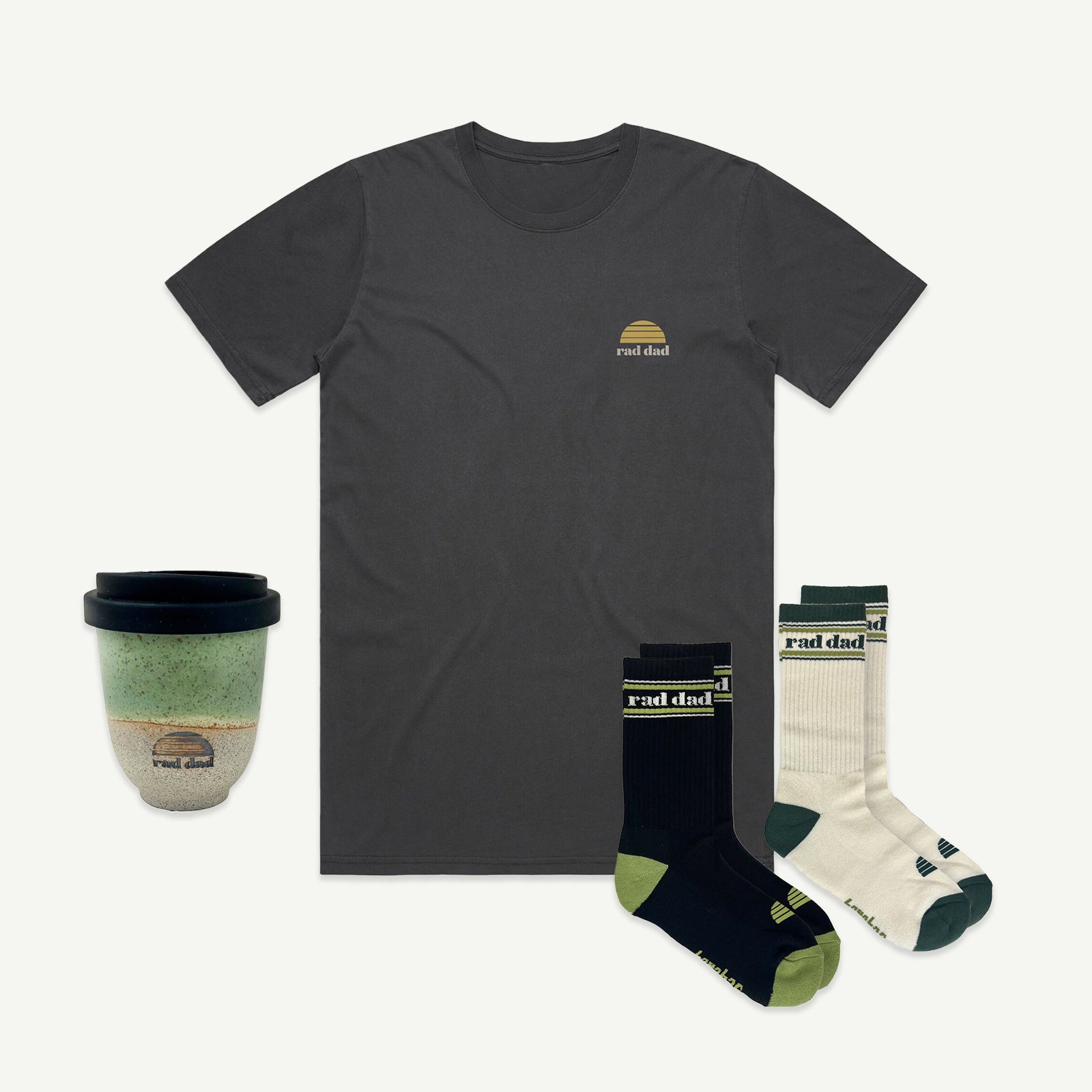 Washed Black t-shirt with 'rad dad' logo, socks, and a mug on a white background